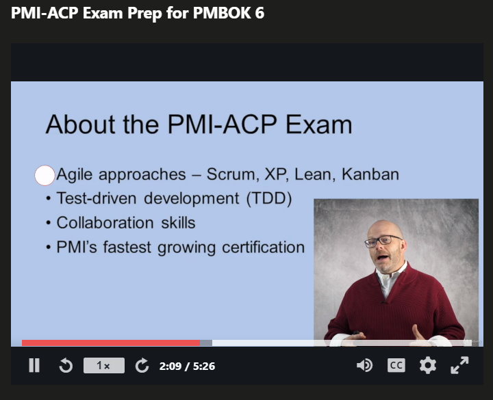 Picture of Joseph's Udemy PMI-ACP PDUs course with a slide showing in the background and him talking.