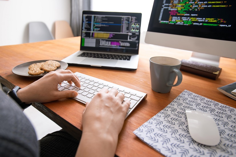 A coder on his computer with code on the screen